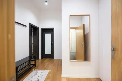 a hallway with white walls and a mirror at U Zlaté hvězdy Kalich in Litoměřice