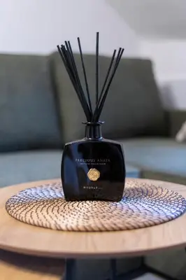 a black vase with sticks in it on a table at 20 seconds to Charles Bridge in Prague