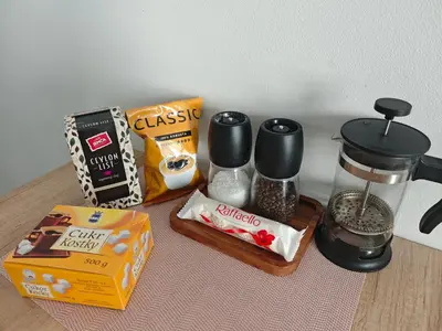 a table with a coffee maker and a box of food at Comfort flat with great location in Prague
