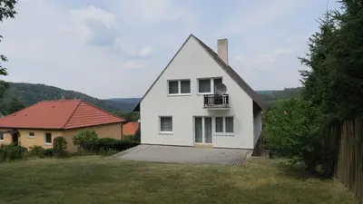 a white house with a balcony in a yard at Holiday home in Krivoklat 1156 in Křivoklát