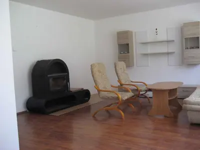 a living room with a fireplace and chairs and a table at Holiday home in Krivoklat 1156 in Křivoklát