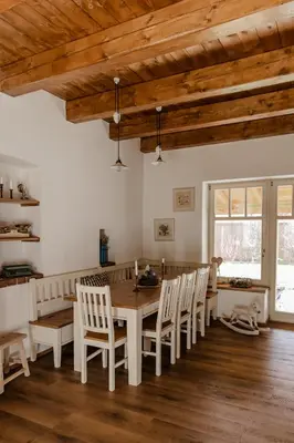 a dining room with a wooden table and chairs at Domeček v Chaloupkách in Zdice
