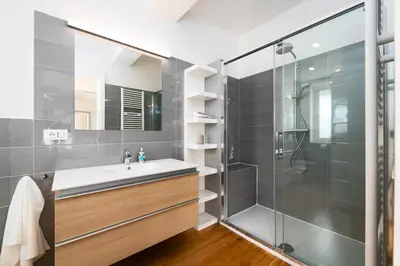 a bathroom with a sink and a shower at Two-level apart with a terrace near the Vltava River in Prague