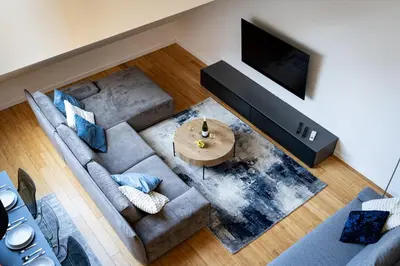an overhead view of a living room with a couch and a television at Two-level apart with a terrace near the Vltava River in Prague