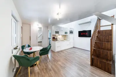 a living room with a couch and a table at Karlín Boutique Loft Residence by LivingClub in Prague
