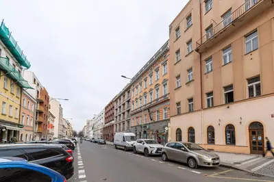 a row of parked cars on a city street at Karlín Boutique Loft Residence by LivingClub in Prague