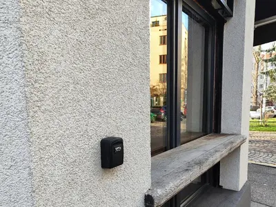 a window with a couch looking out at a parking lot at Apartment Big Windows in Prague