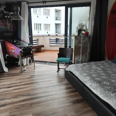 a bedroom with a bed and a desk and a chair at Apartment Big Windows in Prague