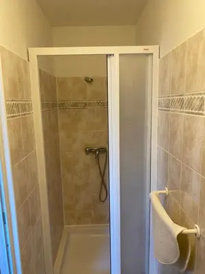 a shower with a glass door in a bathroom at Penzion BeSeDa in Bratronice
