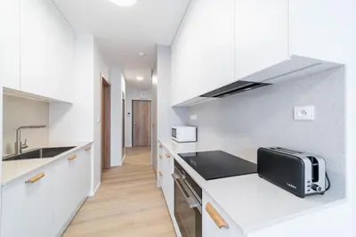 a kitchen with white cabinets and a toaster on a counter at Residence Mozaika in Prague