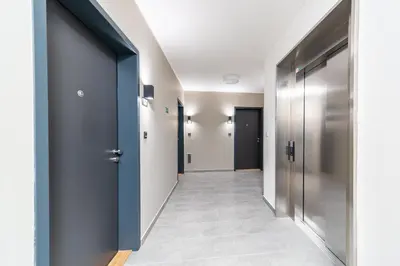 a hallway with blue doors and tile floors at Residence Mozaika in Prague
