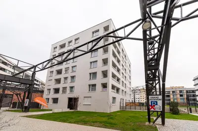 a tall white building with a sign in front of it at Residence Mozaika in Prague