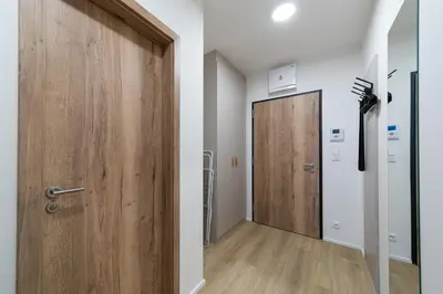 a hallway with a wooden door in a room at Residence Mozaika in Prague