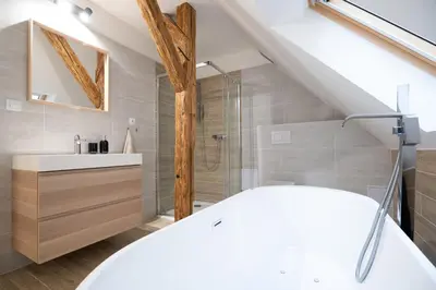 a bathroom with a white tub and a sink at U Zlaté hvězdy Zeibich in Litoměřice