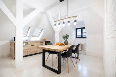 a kitchen and dining room with a wooden table and chairs at U Zlaté hvězdy Zeibich in Litoměřice