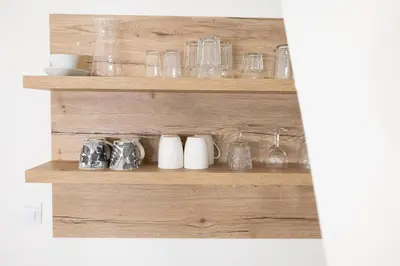 a shelf with glasses and other glass items on it at U Zlaté hvězdy Zeibich in Litoměřice
