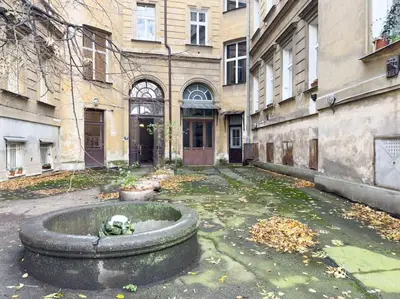 an old building with a fountain in the courtyard at Calm Wenceslas Square Apartment in Prague
