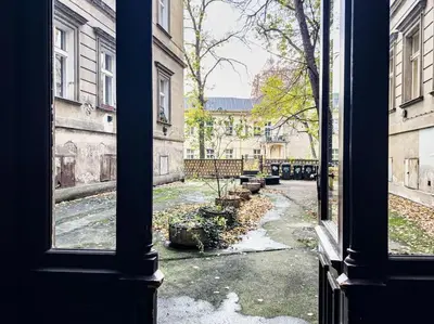 a view of a courtyard from an open window at Calm Wenceslas Square Apartment in Prague