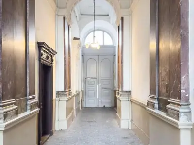 an empty hallway with a white door in a building at Calm Wenceslas Square Apartment in Prague