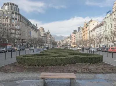 a park in the middle of a city with buildings at Calm Wenceslas Square Apartment in Prague