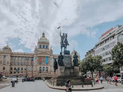 a statue of a man on a horse in front of a building at Calm Wenceslas Square Apartment in Prague