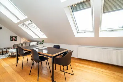 a dining room with skylights and a table and chairs at Luxurious 3bed very spacious apt in the best area in Prague