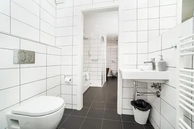 a white bathroom with a toilet and a sink at Luxurious 3bed very spacious apt in the best area in Prague