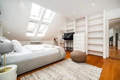 a bedroom with a bed and a tv and shelves at Luxurious 3bed very spacious apt in the best area in Prague