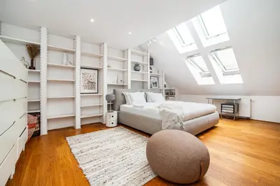 a bedroom with white shelves and a bed with a rug at Luxurious 3bed very spacious apt in the best area in Prague
