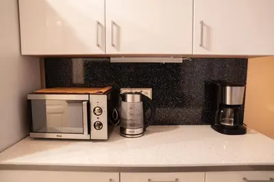 a kitchen counter with a microwave and a coffee maker at Cozy flat by Wenceslas Square! in Prague