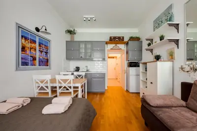 a kitchen and living room with a bed and a table at Centrum Bohemia LUX in Prague