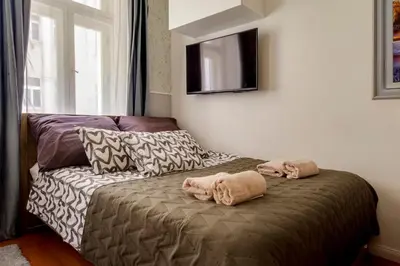 a room with a couch and two towels on a bed at Centrum Bohemia LUX in Prague