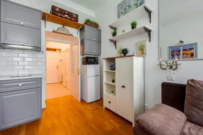 a kitchen with white cabinets and a refrigerator at Centrum Bohemia LUX in Prague