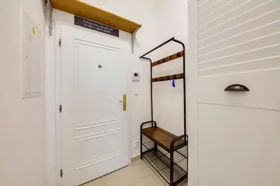 a hallway with a white door and a stair case at Centrum Bohemia LUX in Prague