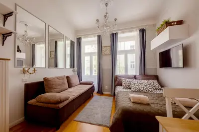 a living room with a couch and a chair at Centrum Bohemia LUX in Prague