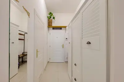 a hallway with white walls and a white door at Centrum Bohemia LUX in Prague