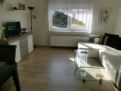 a living room with a glass table and a television at Apartmán Ptice in Ptice