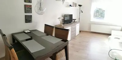 a dining room with a table and a television at Apartmán Ptice in Ptice