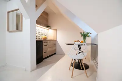 a kitchen with white walls and a table with a plant at U Zlaté hvězdy Jakub in Litoměřice