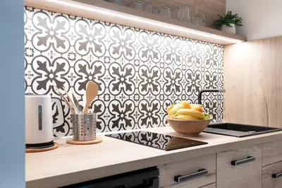 a kitchen with a black and white patterned wall at U Zlaté hvězdy Jakub in Litoměřice