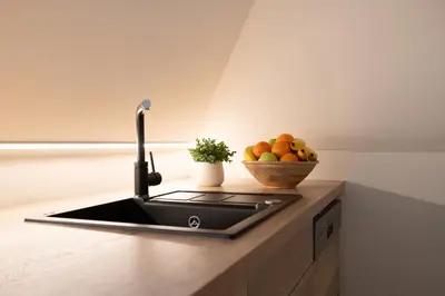 a kitchen with a sink and a bowl of fruit at U Zlaté hvězdy, Karel IV in Litoměřice