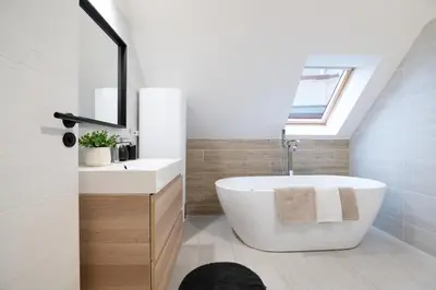 a bathroom with a tub and a sink and a window at U Zlaté hvězdy, Karel IV in Litoměřice