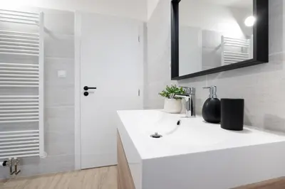 a white bathroom with a sink and a mirror at U Zlaté hvězdy, Karel IV in Litoměřice