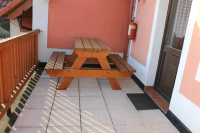 a bench sitting on the porch of a house at Penzion Na Statku in Starý Vestec