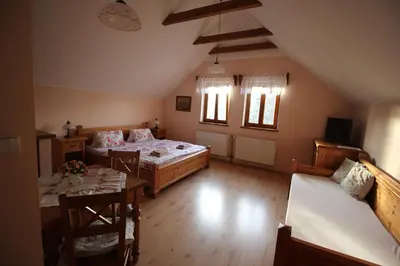 a bedroom with a bed and a table and chairs at Penzion Na Statku in Starý Vestec