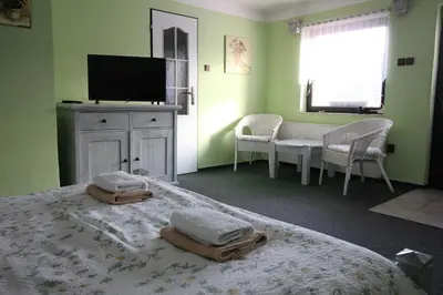 a bedroom with a bed with two pillows on it at Penzion Na Statku in Starý Vestec