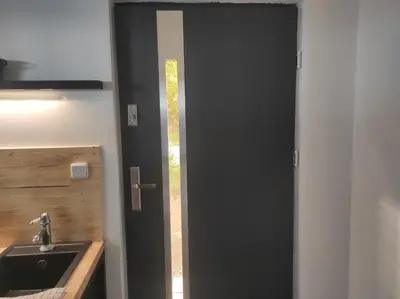 a bathroom with a black door and a sink at Klid in Budyně nad Ohří