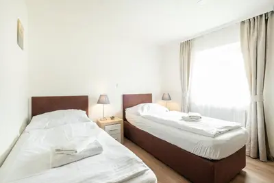 two beds in a bedroom with a window at Hotel U Císaře in Mirošovice