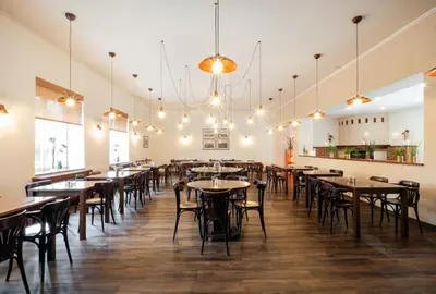 a room with tables and chairs in a restaurant at Hotel U Císaře in Mirošovice