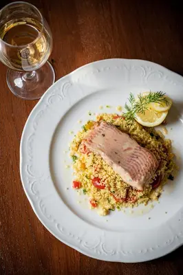 a plate of food with a piece of meat on top of rice at Hotel U Císaře in Mirošovice